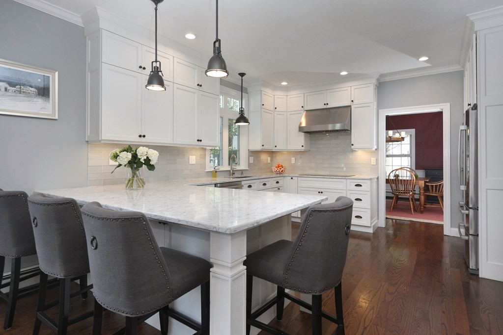 3 Magnolia Road Natick, MA 01760 - Photo 11 of 35 a kitchen with a dining table chairs sink and cabinets