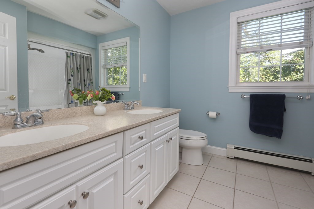 3 Magnolia Road Natick, MA 01760 - Photo 22 of 35 a bathroom with a granite countertop toilet sink and mirror