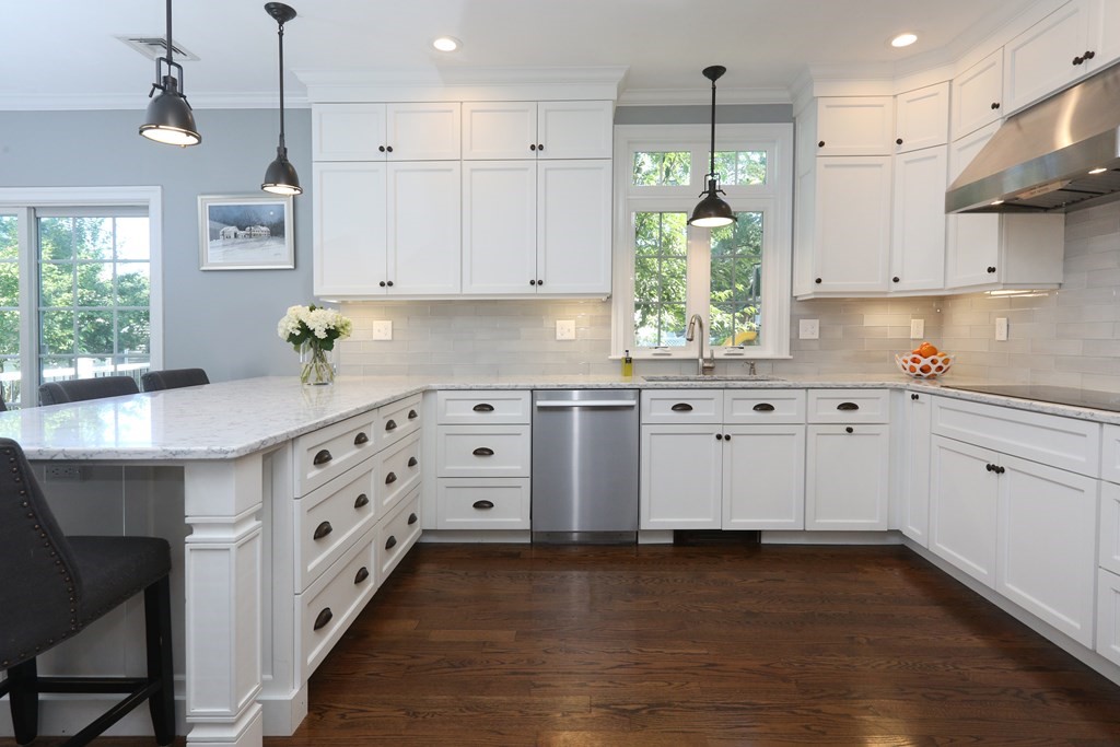 3 Magnolia Road Natick, MA 01760 - Photo 8 of 35 a kitchen with granite countertop a white stove top oven sink and cabinets