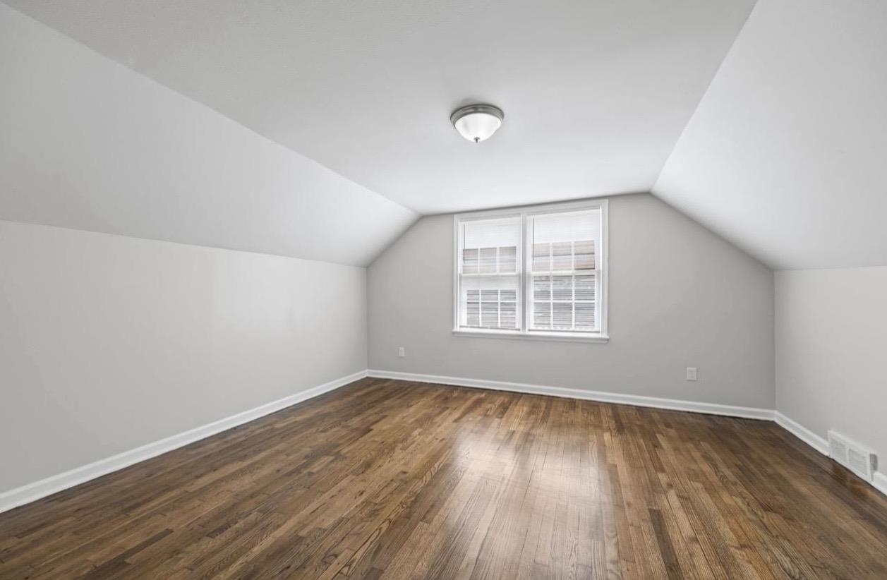 3843 Blue Jay Road Memphis, TN 38116 - Photo 17 of 23 an empty room with wooden floor and windows