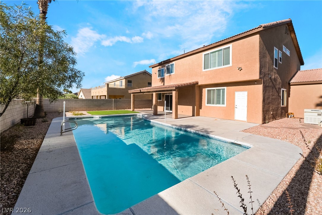 261 Timber Hollow Street Henderson, NV 89012 - Photo 44 of 51 A tranquil backyard pool awaits, surrounded by ample patio space for outdoor enjoyment.