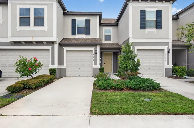 a front view of a house with a yard and garage