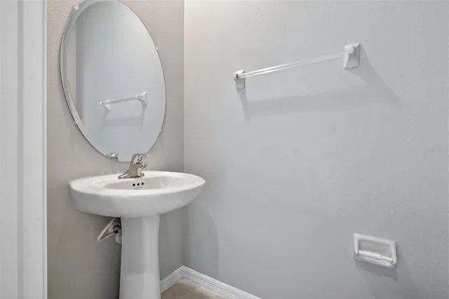 a bathroom with a sink a mirror and shower