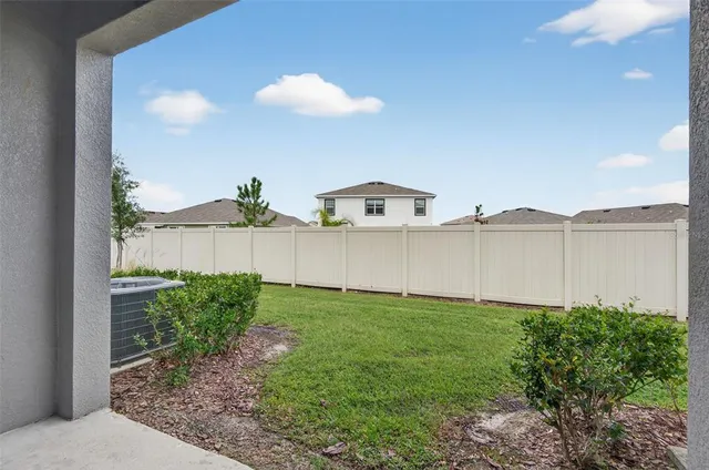 a view of a backyard with plants and lake view