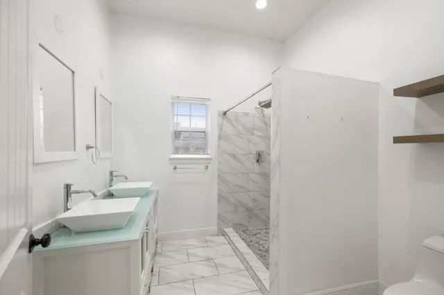 a bathroom with a sink toilet and shower