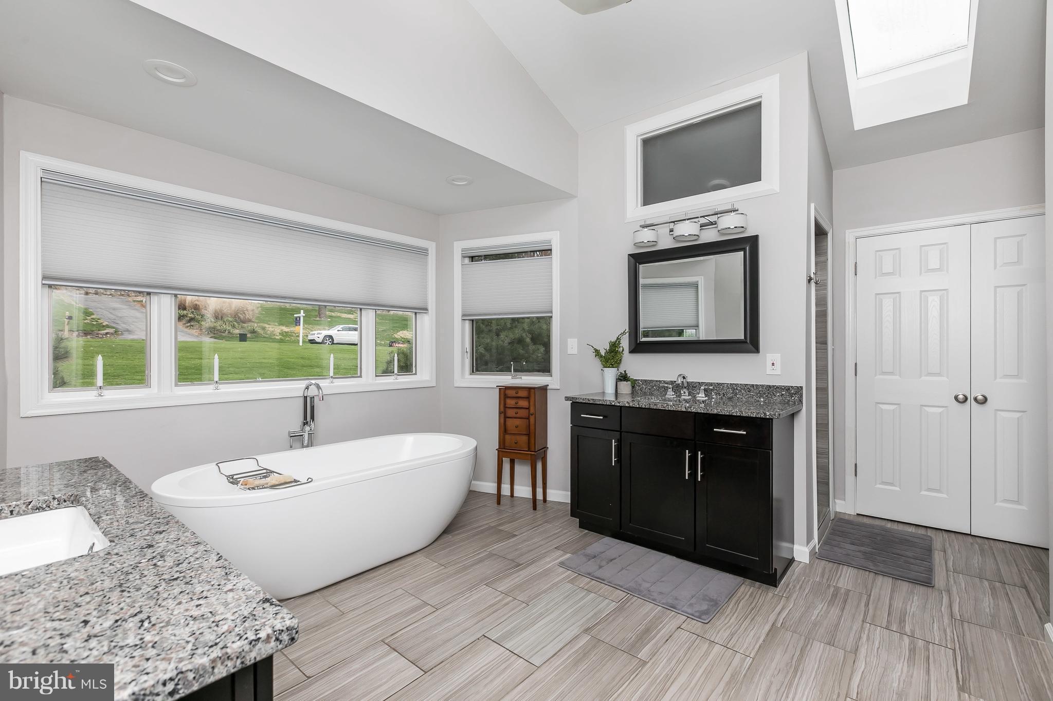 1310 Milldam Road Baltimore, MD 21286 - Photo 14 of 29 a spacious bathroom with a granite countertop tub and a sink