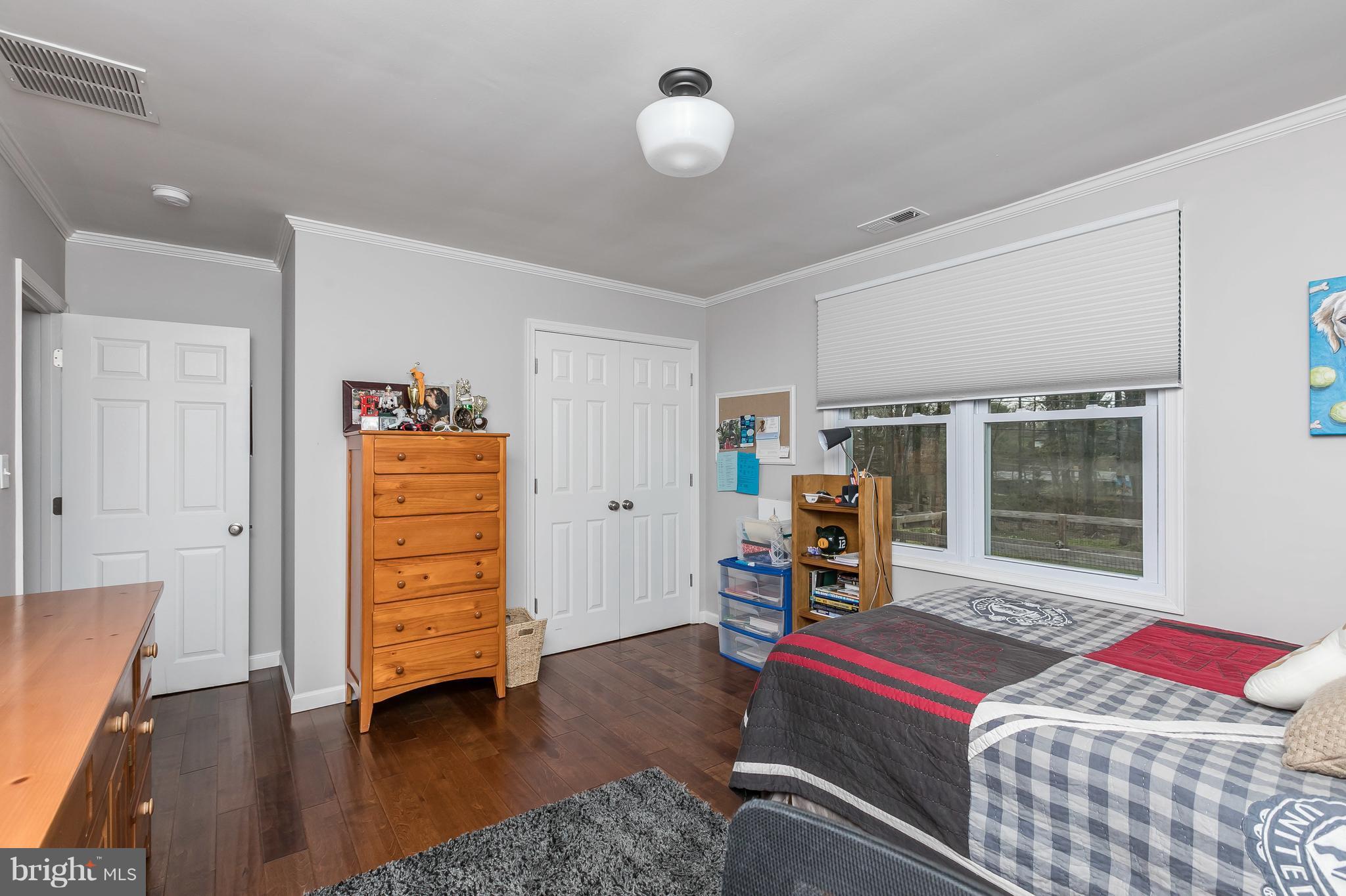 1310 Milldam Road Baltimore, MD 21286 - Photo 17 of 29 a bedroom with furniture and wooden floor