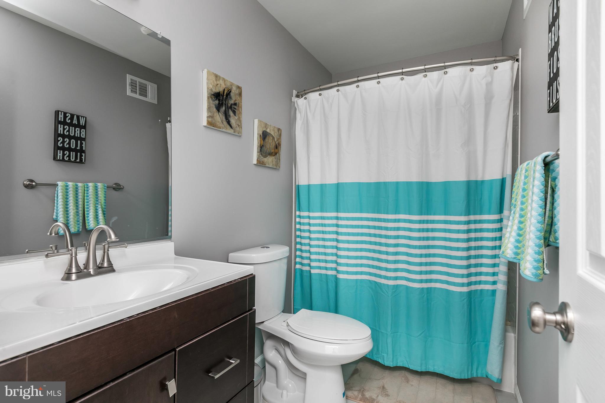 1310 Milldam Road Baltimore, MD 21286 - Photo 18 of 29 a bathroom with a sink a toilet and mirror