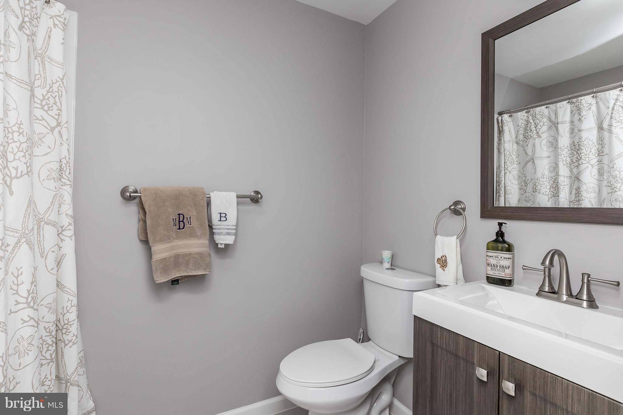 1310 Milldam Road Baltimore, MD 21286 - Photo 20 of 29 a bathroom with a toilet sink vanity and mirror