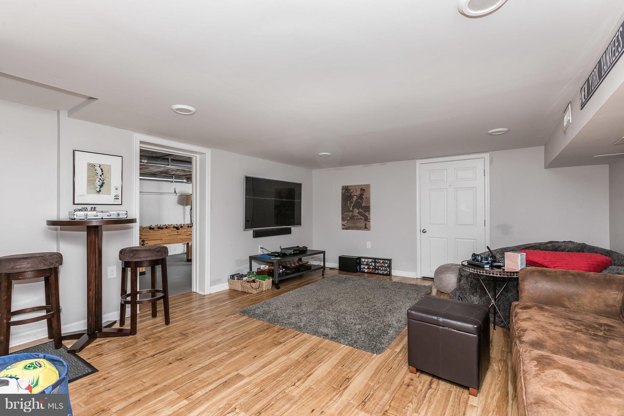 1310 Milldam Road Baltimore, MD 21286 - Photo 22 of 29 a living room with furniture and a flat screen tv