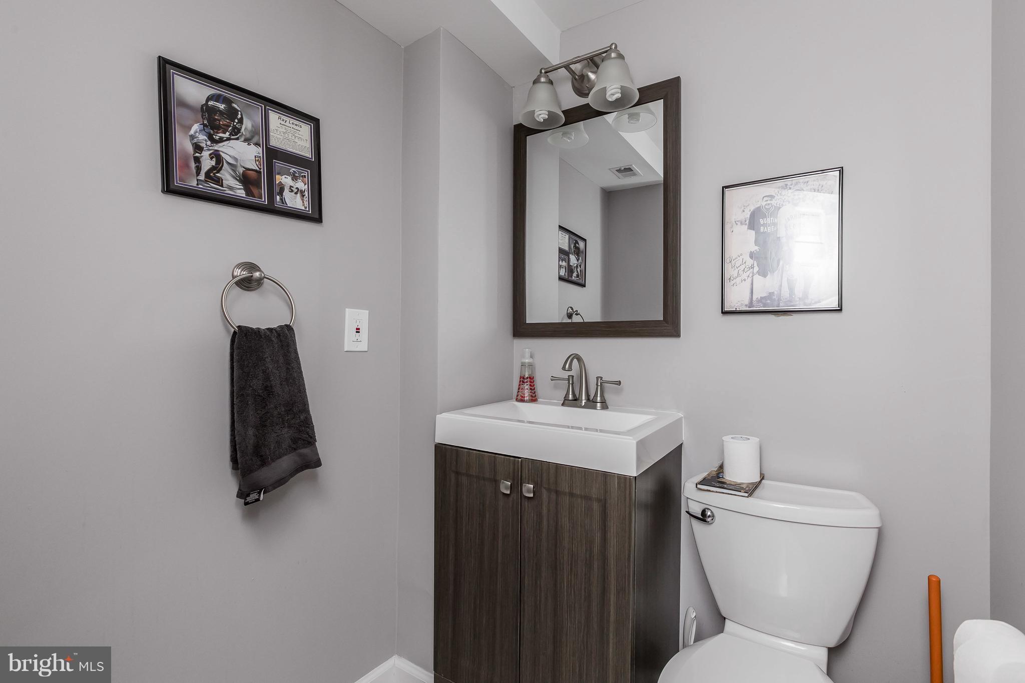 1310 Milldam Road Baltimore, MD 21286 - Photo 23 of 29 a bathroom with a toilet a sink and mirror