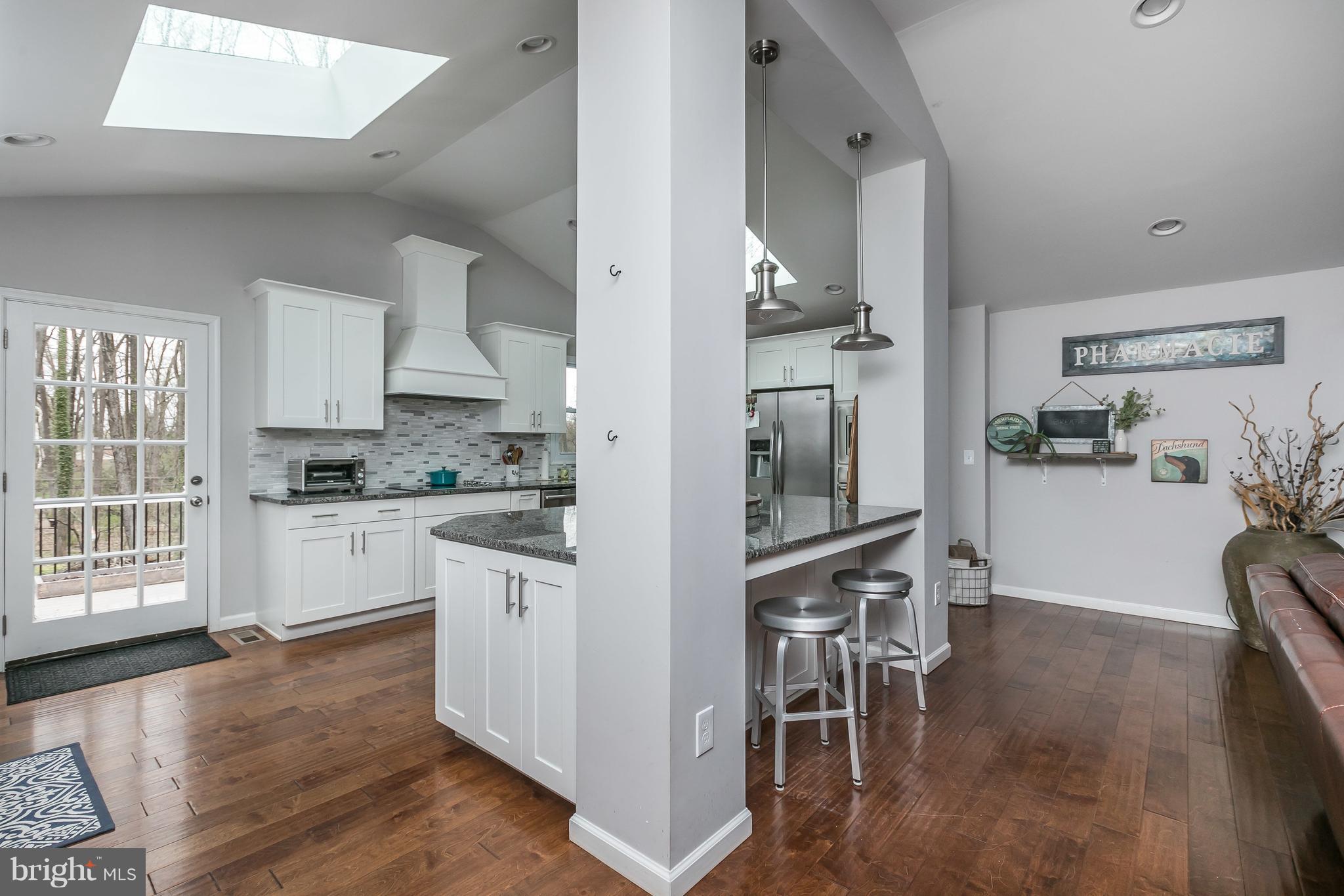 1310 Milldam Road Baltimore, MD 21286 - Photo 6 of 29 a kitchen with stainless steel appliances wooden floor and a refrigerator