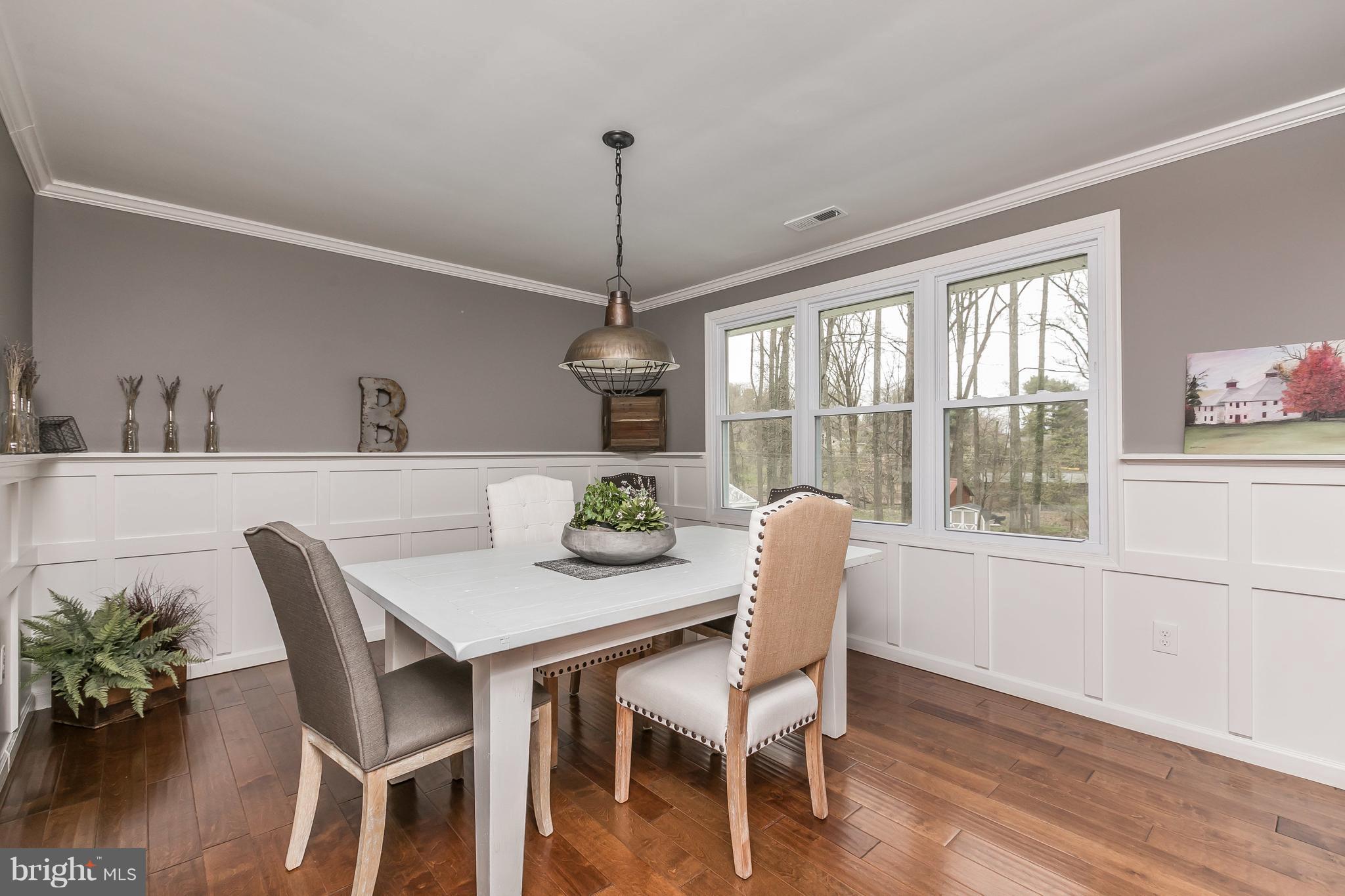 1310 Milldam Road Baltimore, MD 21286 - Photo 9 of 29 a dining room with furniture a window and wooden floor