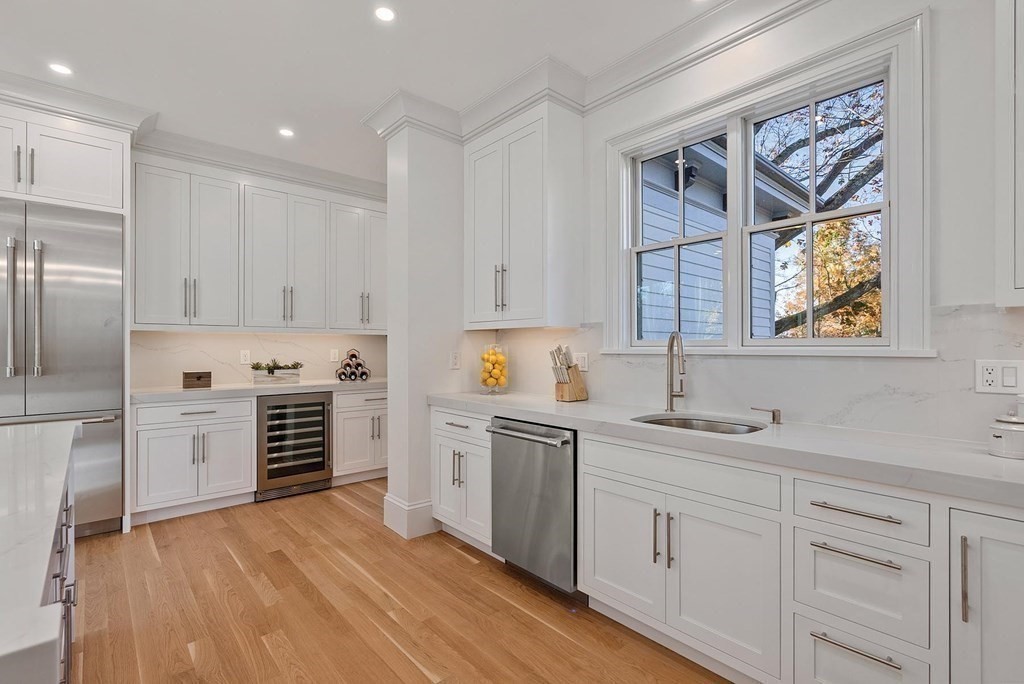 15 Sterling Street Newton, MA 02465 - Photo 15 of 39 a kitchen with white cabinets and stainless steel appliances