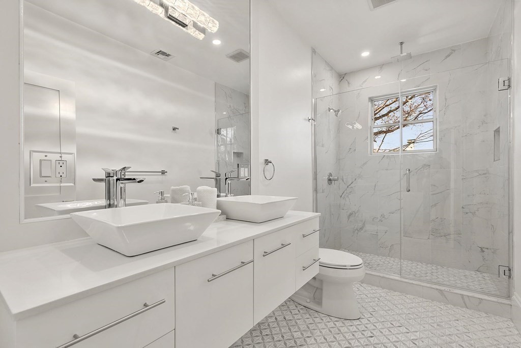 15 Sterling Street Newton, MA 02465 - Photo 23 of 39 a bathroom with a double vanity sink toilet and shower