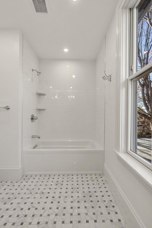 15 Sterling Street Newton, MA 02465 - Photo 29 of 39 a bathroom with a bathtub and a shower