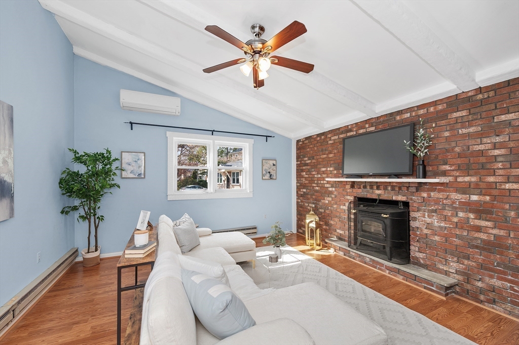 10 Parker Road Newton, MA 02459 - Photo 8 of 27 a living room with furniture a fireplace and a flat screen tv