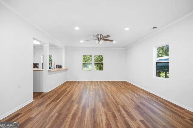 wooden floor in an empty room with a window