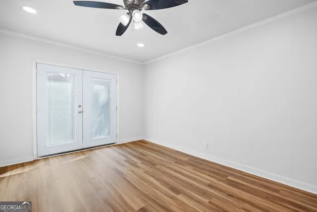 a view of an empty room with wooden floor