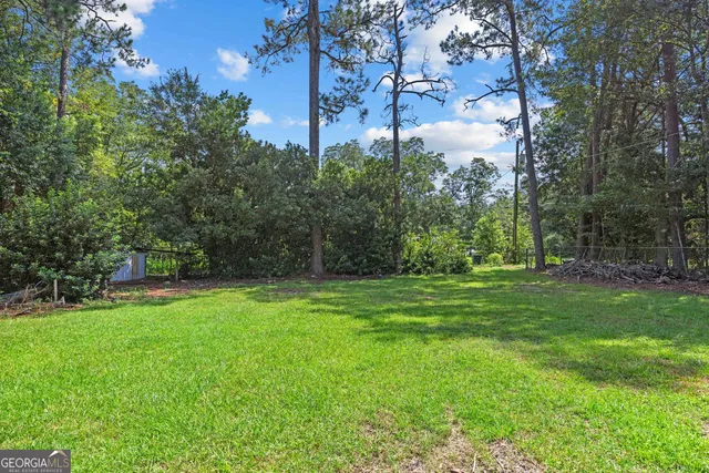 a view of a backyard with large trees