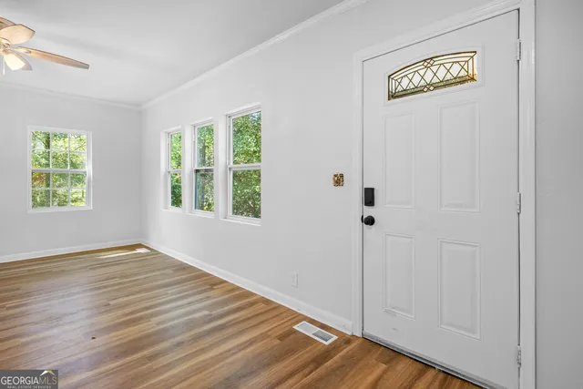 a view of an entryway with wooden floor and windows