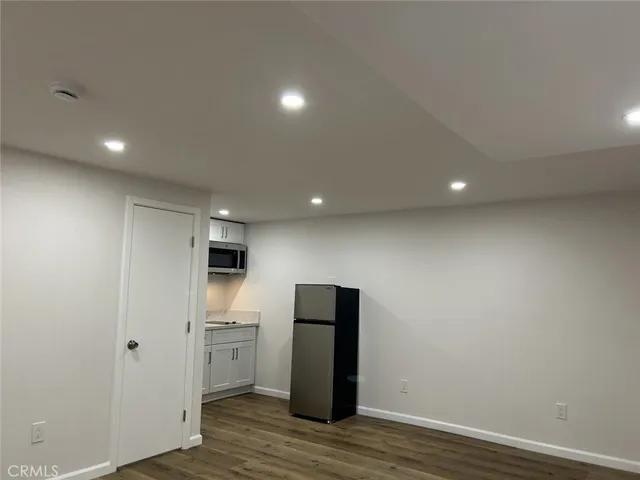 a view of a kitchen with a refrigerator and a stove