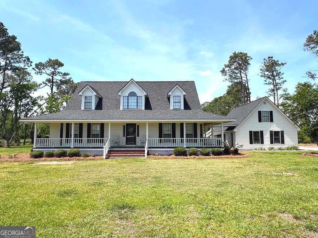 a front view of a house with swimming pool having outdoor seating