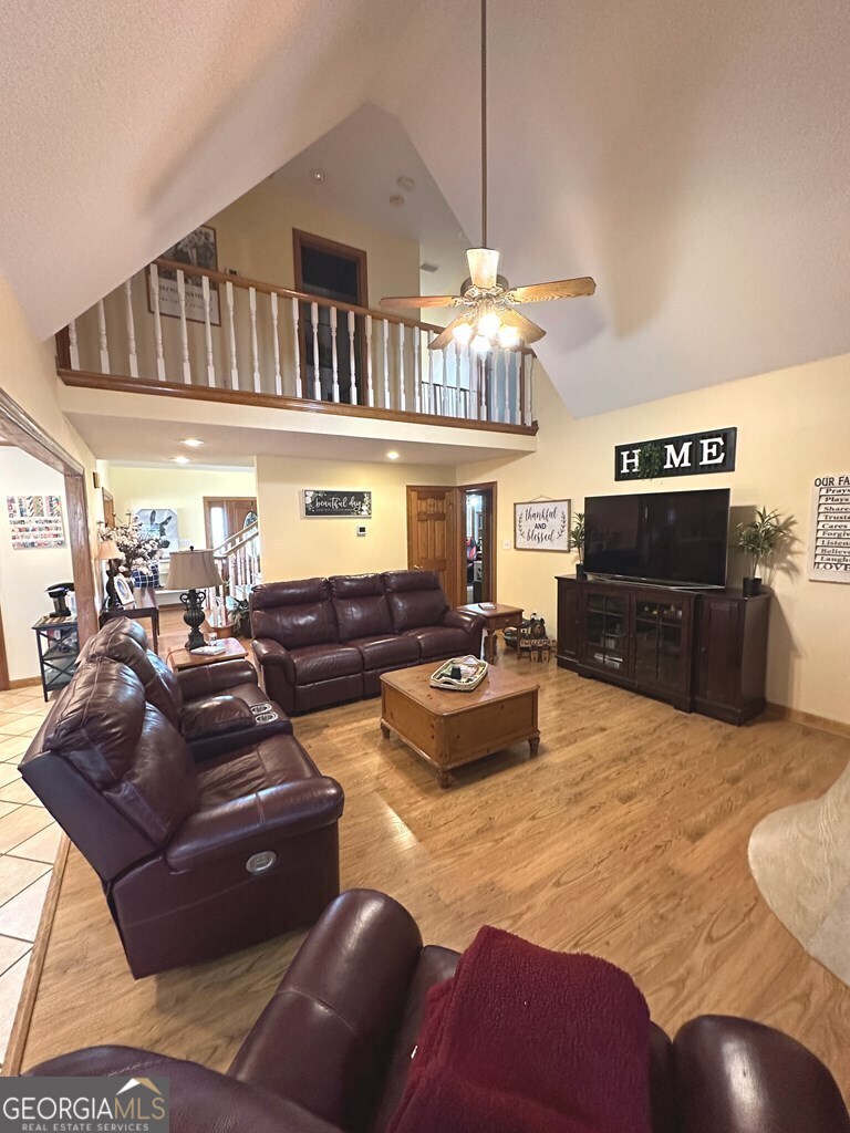 4448 Old Lake Park Road Valdosta, GA 31606 - Photo 12 of 40 a living room with furniture kitchen view and a chandelier