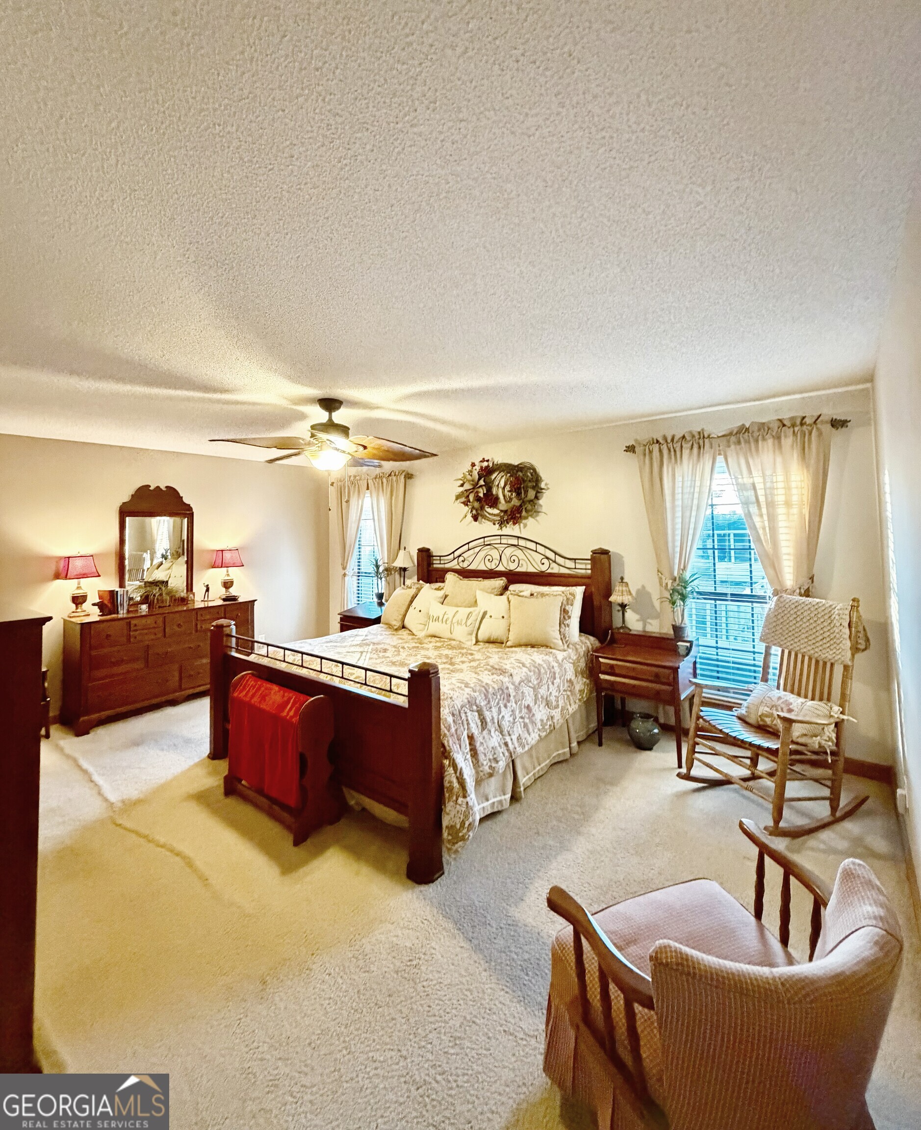 4448 Old Lake Park Road Valdosta, GA 31606 - Photo 13 of 40 a spacious bedroom with a bed and a couch