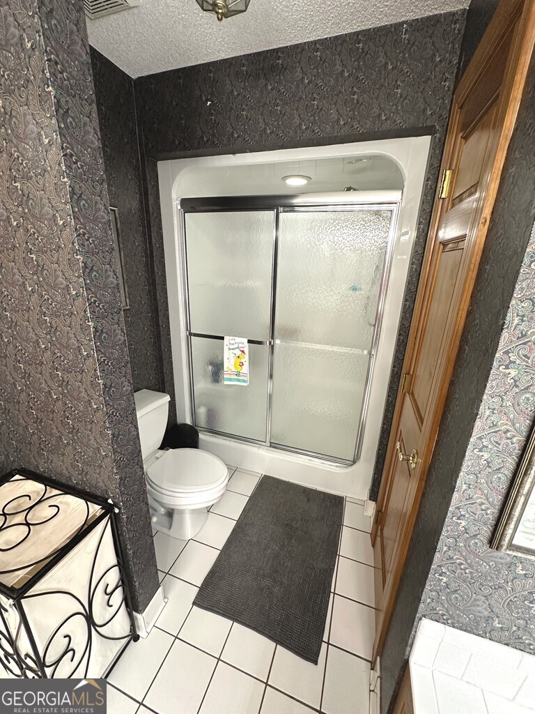 4448 Old Lake Park Road Valdosta, GA 31606 - Photo 16 of 40 a bathroom with a toilet and a shower