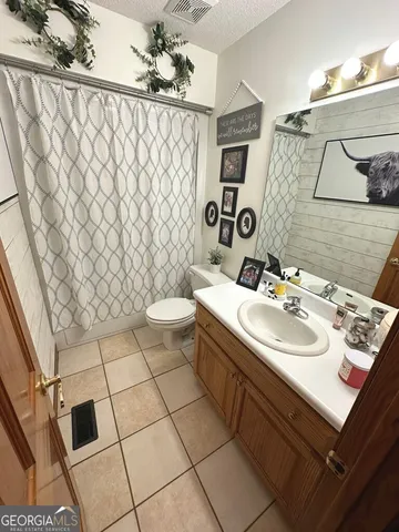 a bathroom with a sink toilet and mirror