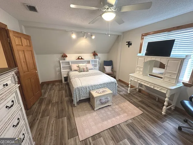 a bedroom with a bed and flat screen tv
