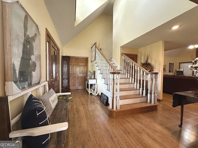 a view of a livingroom with furniture and staircase