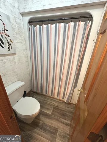 a bathroom with a toilet a sink and a mirror