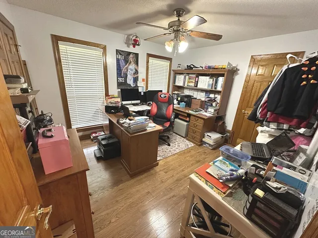 a living room with furniture a flat screen tv and a window