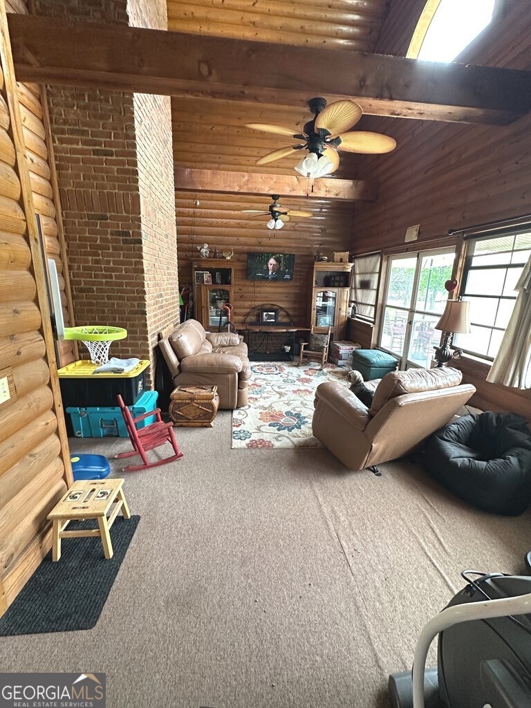 4448 Old Lake Park Road Valdosta, GA 31606 - Photo 25 of 40 a living room with furniture a flat screen tv and a large window