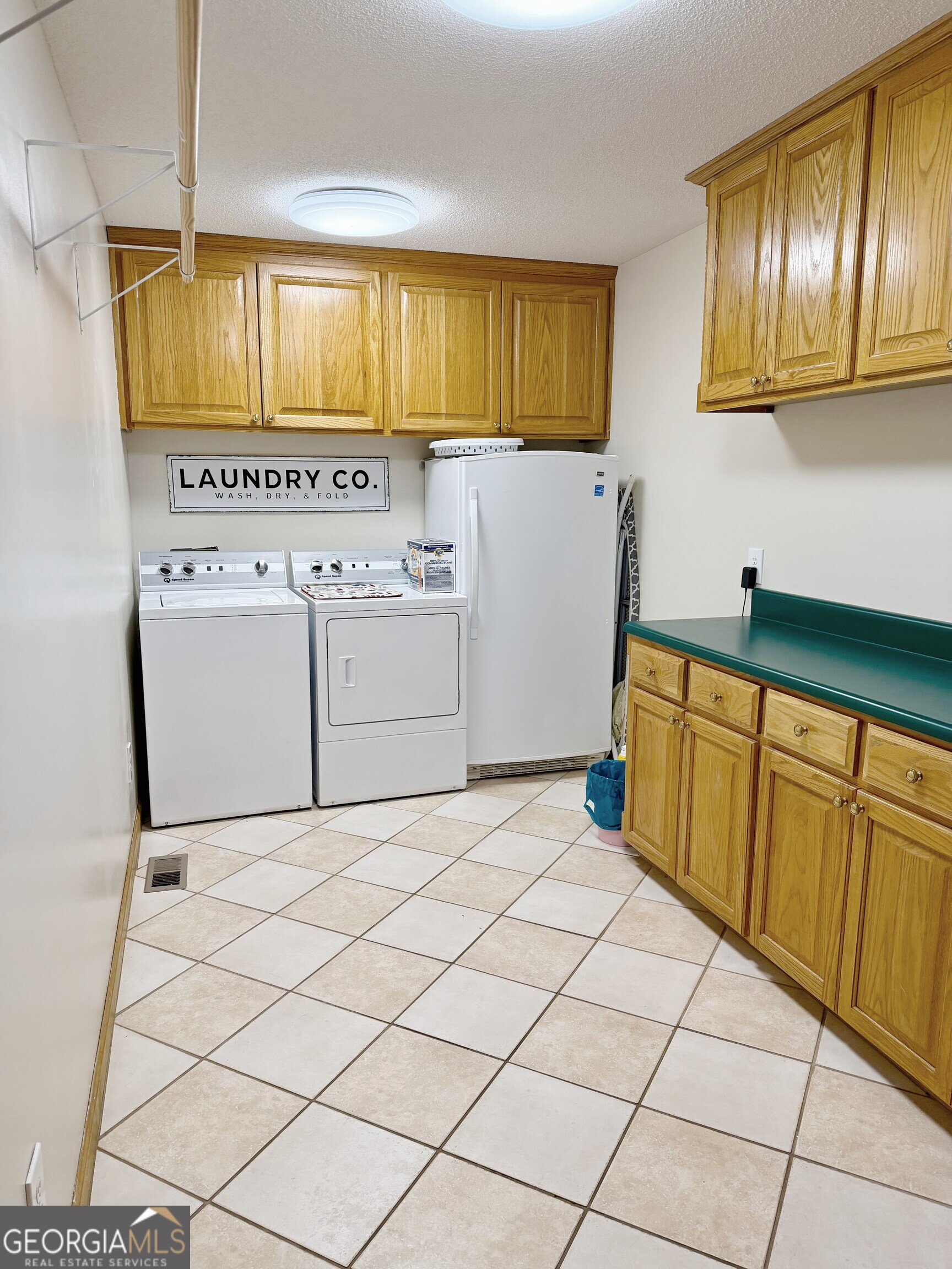 4448 Old Lake Park Road Valdosta, GA 31606 - Photo 29 of 40 a utility room with cabinets