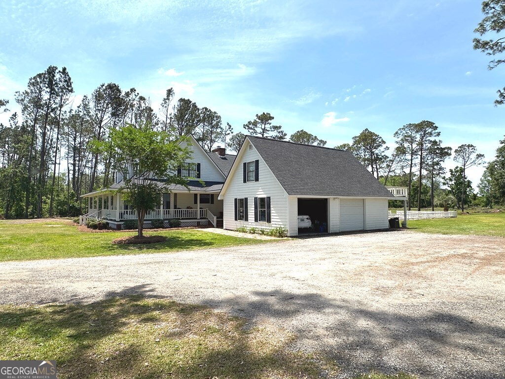 4448 Old Lake Park Road Valdosta, GA 31606 - Photo 34 of 40 a front view of a house with a yard and trees