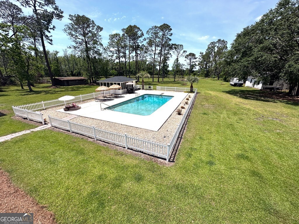 4448 Old Lake Park Road Valdosta, GA 31606 - Photo 35 of 40 a view of a house with swimming pool and a yard