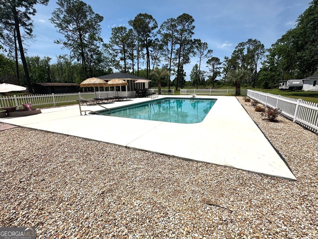 4448 Old Lake Park Road Valdosta, GA 31606 - Photo 38 of 40 a swimming pool with some trees in the background