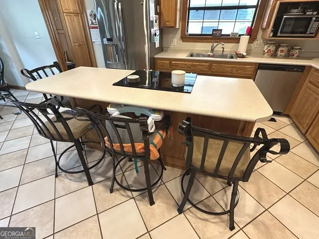 a view of a dining room with furniture and a chandelier