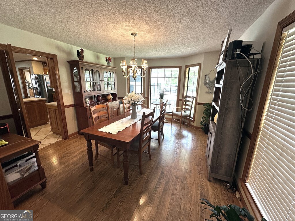4448 Old Lake Park Road Valdosta, GA 31606 - Photo 7 of 40 a view of a dining room with furniture window and wooden floor