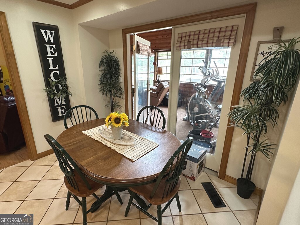 4448 Old Lake Park Road Valdosta, GA 31606 - Photo 8 of 40 a view of a dining room with furniture and window