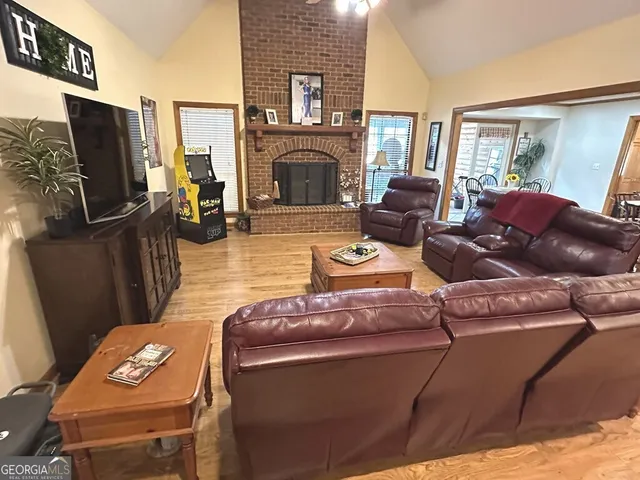 a living room with furniture a fireplace and a flat screen tv