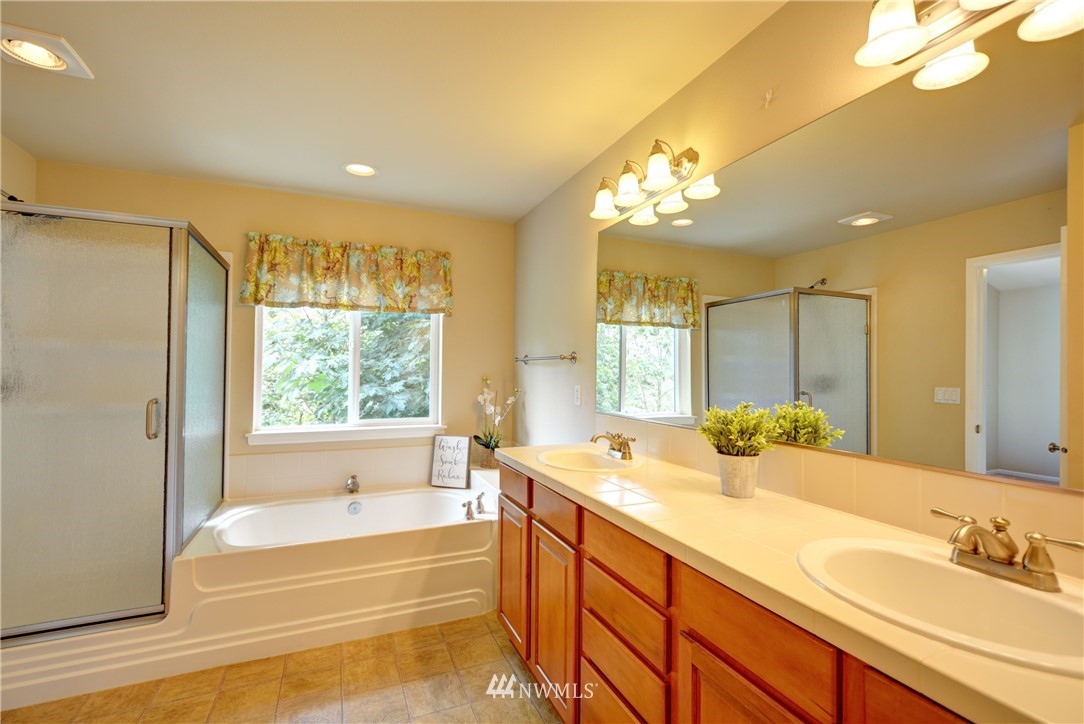 16229 35th Park Southeast Bothell, WA 98012 - Photo 12 of 23 a spacious bathroom with a tub sink and mirror