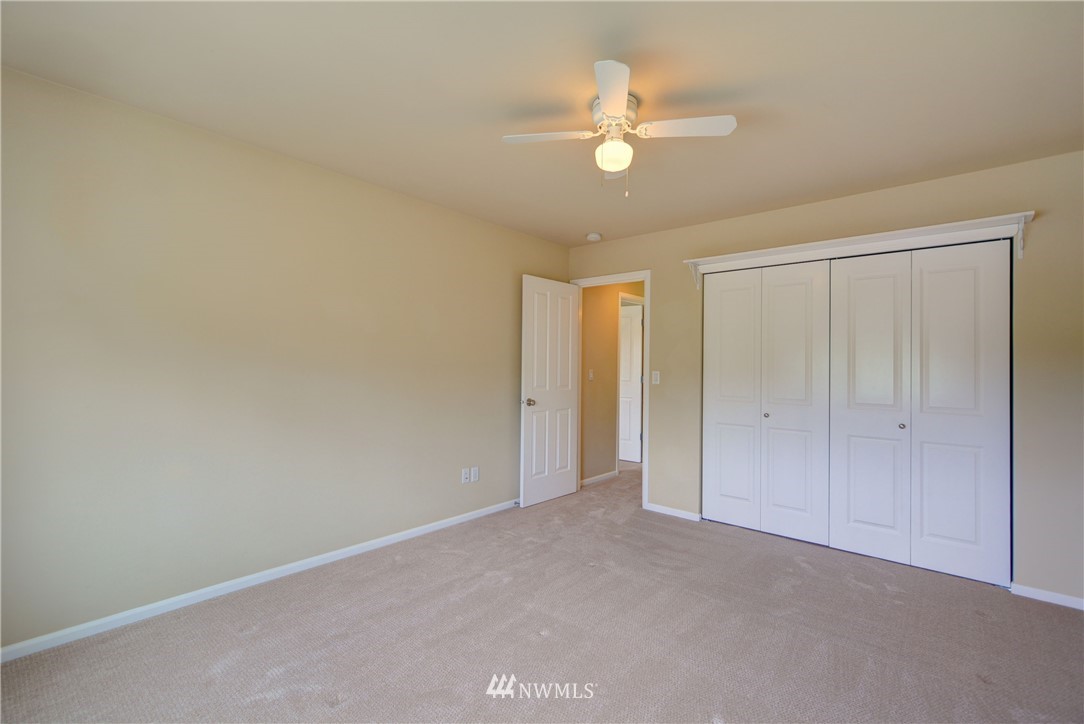 16229 35th Park Southeast Bothell, WA 98012 - Photo 16 of 23 an empty room with a chandelier fan and windows