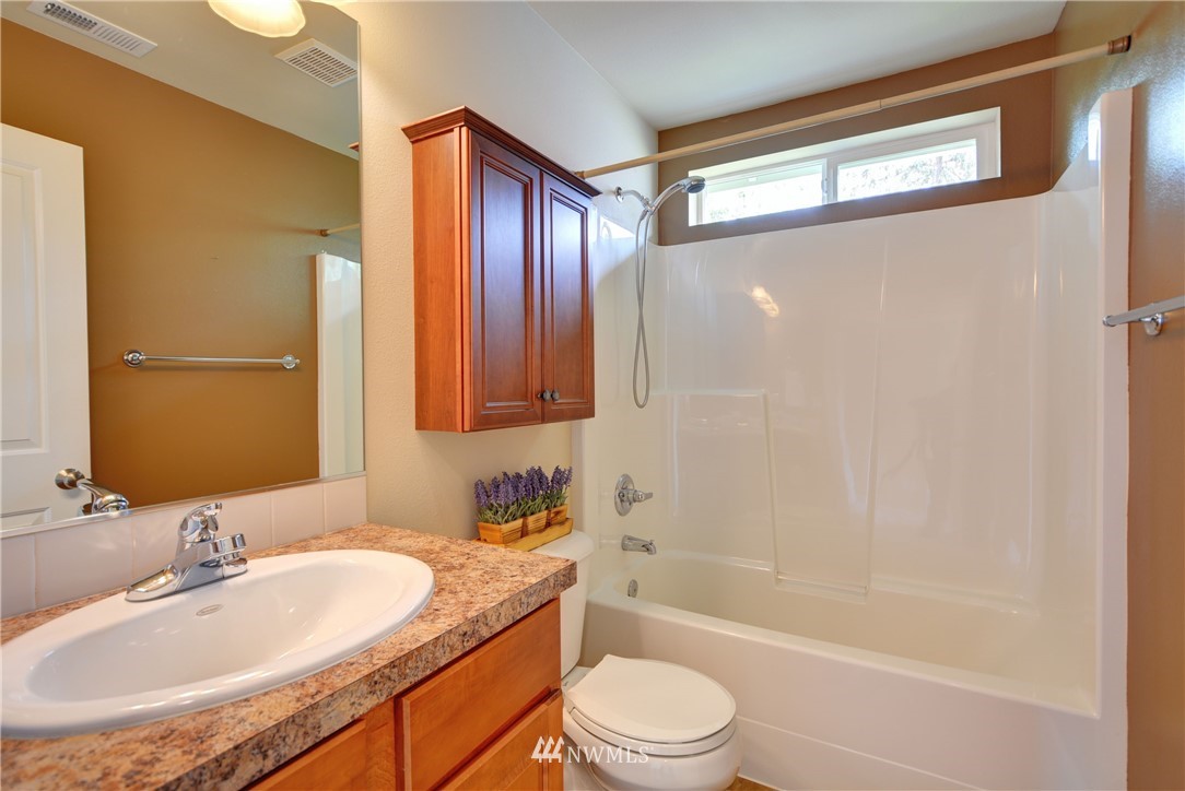 16229 35th Park Southeast Bothell, WA 98012 - Photo 18 of 23 a bathroom with a granite countertop sink toilet and shower