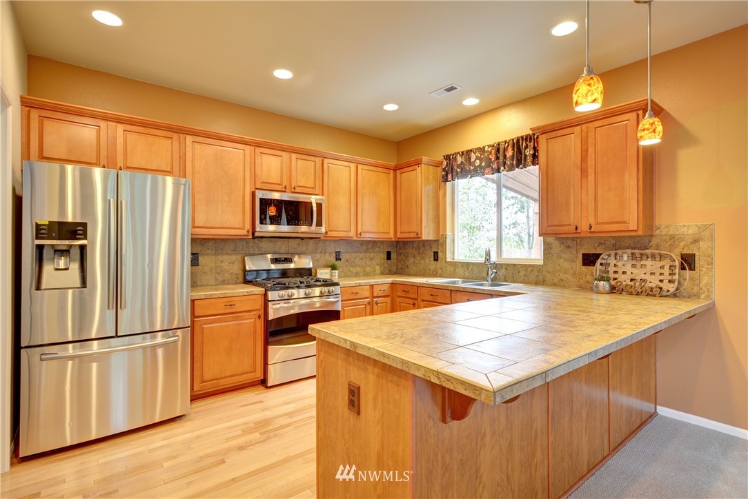 16229 35th Park Southeast Bothell, WA 98012 - Photo 5 of 23 a kitchen with a refrigerator a microwave and sink