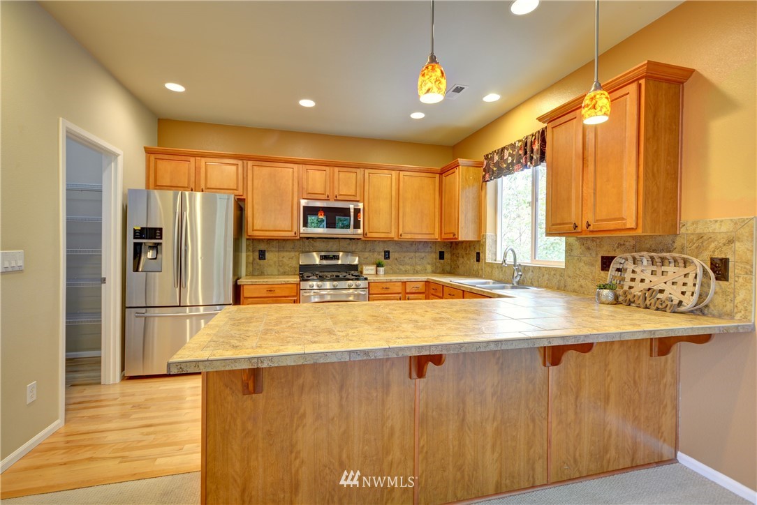 16229 35th Park Southeast Bothell, WA 98012 - Photo 6 of 23 a kitchen with stainless steel appliances a refrigerator sink and microwave