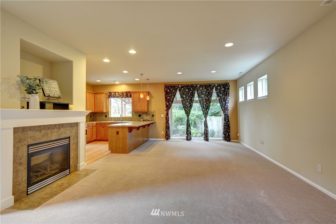 16229 35th Park Southeast Bothell, WA 98012 - Photo 9 of 23 a open kitchen with a fireplace and a view of living room
